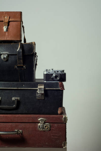 istock Stack of vintage shabby suitcases and camera 840416100