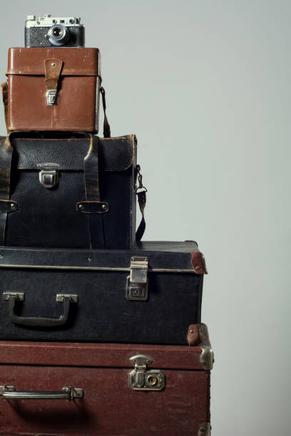 istock Stack of vintage shabby suitcases and camera 840416138