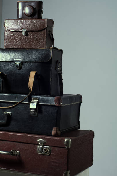 istock Background stack of old shabby suitcase with a camera in bag. 840416144
