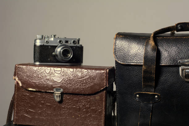 istock Close-up of a stack vintage shabby suitcases and camera 840416154