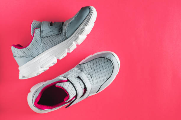 istock Grey sneakers on pink background. Flat lay and top view 840419304