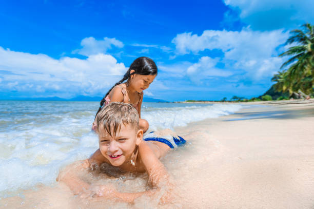 istock Two kids having fun on the sunny tropical beach 840421330