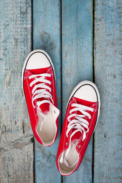 istock Red retro sneakers on a blue wooden background 840424164