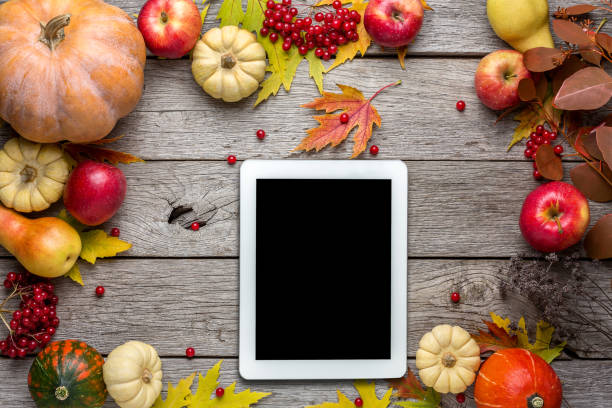 Seasonal background with autumn harvest and tablet