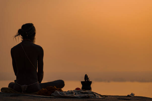 yogi on the shore of the gang - shiva posture imagens e fotografias de stock