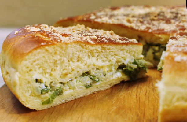 istock Ruddy baked onion and eggs pie on wooden table close up 840436108