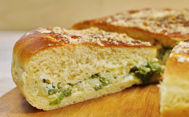 istock Ruddy baked onion and eggs pie on wooden table close up 840436110