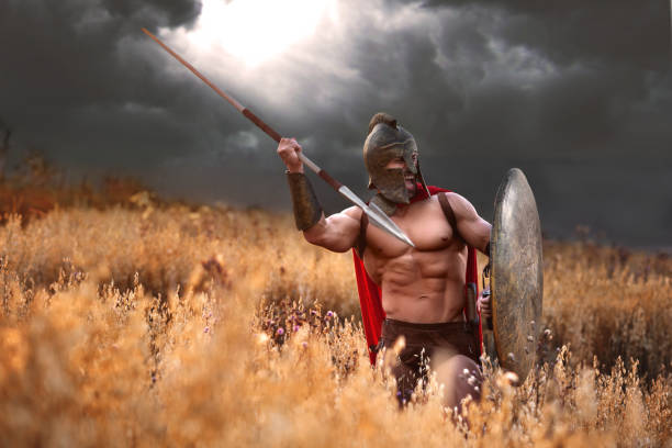 istock Strong Spartan warrior in battle dress with a shield and a spear 840439292