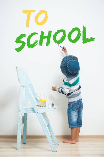 istock A little boy is painting with paint on the wall. 840439824
