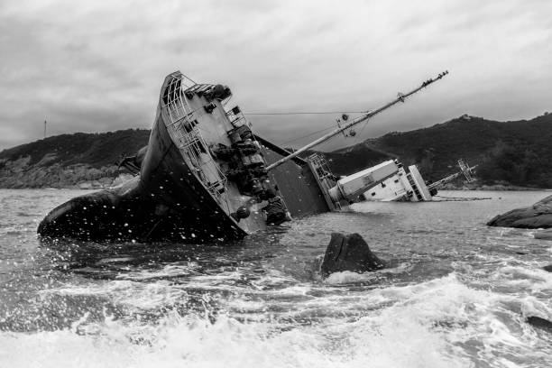 nave naufragata lungo la costa rocciosa (bianco e nero) - albero di bompresso foto e immagini stock