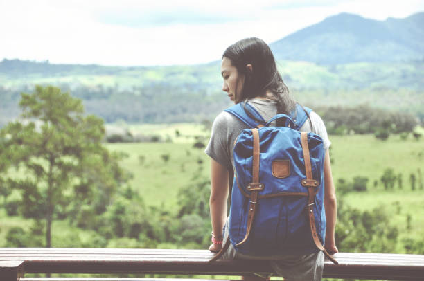 istock woman traveler looking at mountain view 840456874