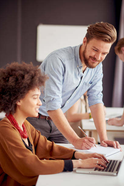 istock Businessman helping his mixed race colleague 840458334