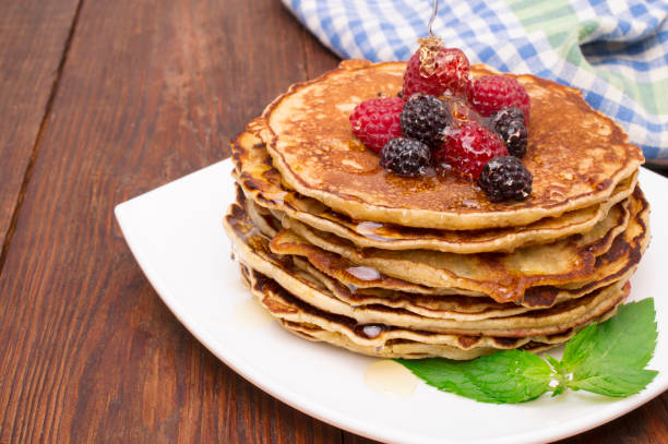 istock Delicious pancakes with berries and maple syrup 840462062