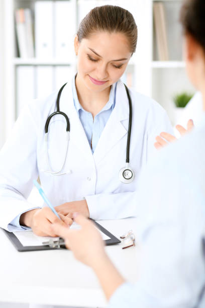istock Friendly smiling doctor  and  patient sitting at the table 840462790