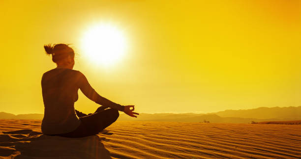 woman doing yoga at sunset