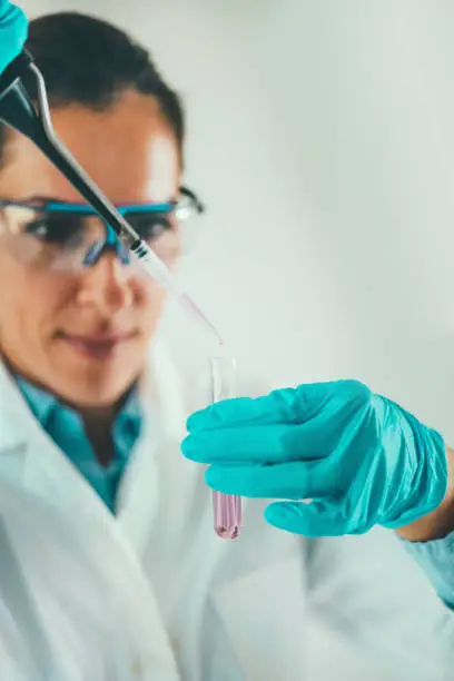 Photo of Laboratory technician using micro pipette