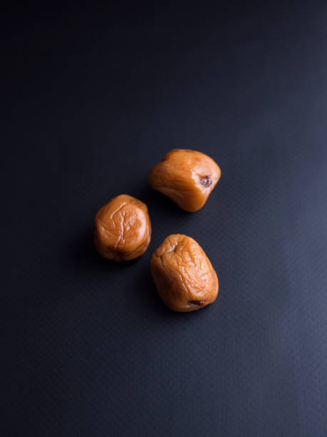 istock Japanese umeboshi plums isolated on black background 840471984