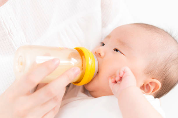 istock Baby drinking milk in a baby bottle 840473164