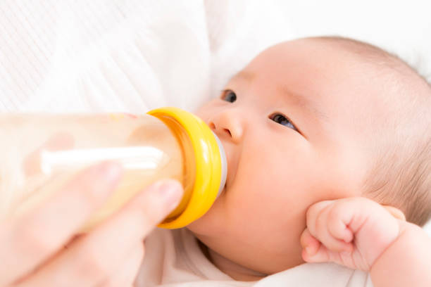 Baby drinking milk in a baby bottle