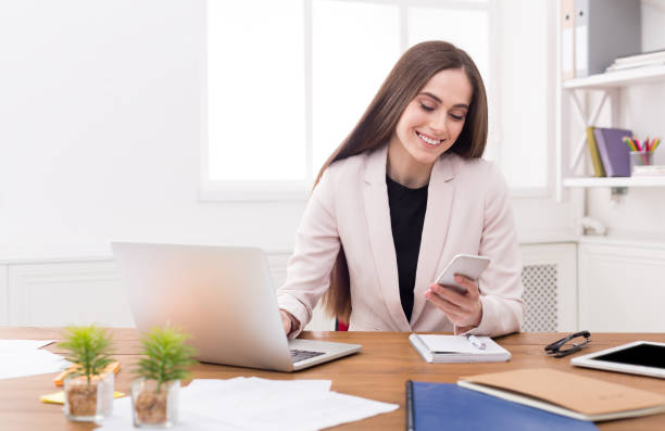 istock Young business woman working on phone 840473564