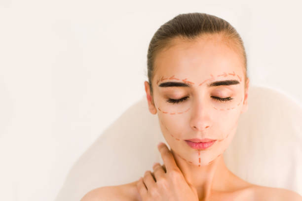 istock Attractive girl with correction lines on her face. 840477340