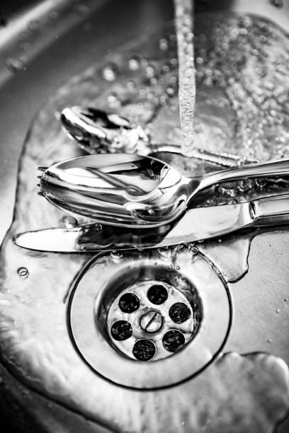 istock Cutlery in the kitchen sink under running water 840481720