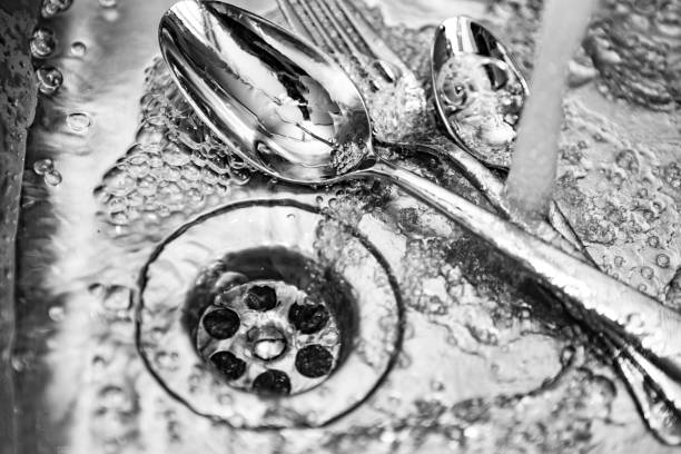 istock Cutlery in the kitchen sink under running water 840481754