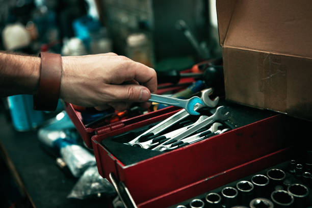 There's nothing that can't be fixed with the right tools Cropped shot of man’s hand reaching for a tool from his toolbox open end spanner stock pictures, royalty-free photos & images