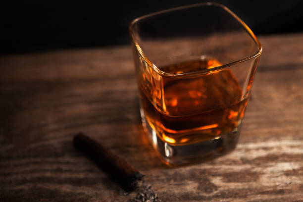 istock Glass with whiskey and cigar on the table 840489198