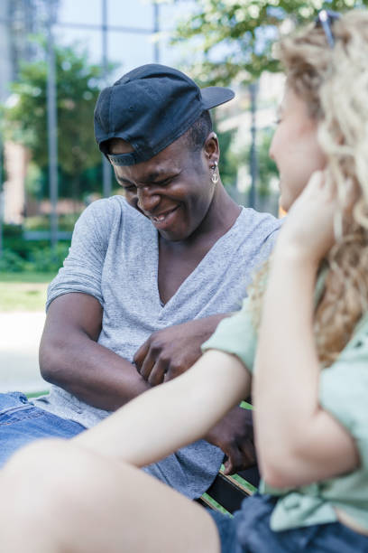 istock Loving couple talking on bench in a park during summer 840492146