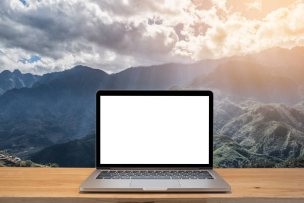 istock Laptop computer and coffee on workspace and mountain at morning fresh background,vintage tone. 840492944