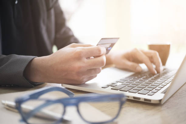 istock Online payment,Man's hands holding a credit card and using laptop computer for online shopping 840493088