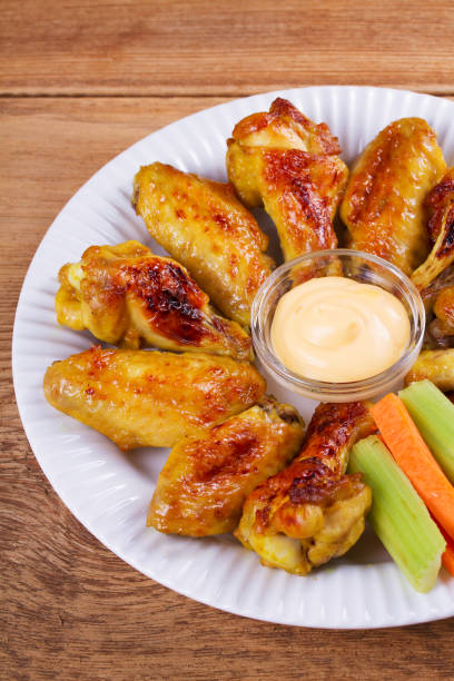 istock Chicken wings buffalo. Chicken with celery and carrot sticks 840493582