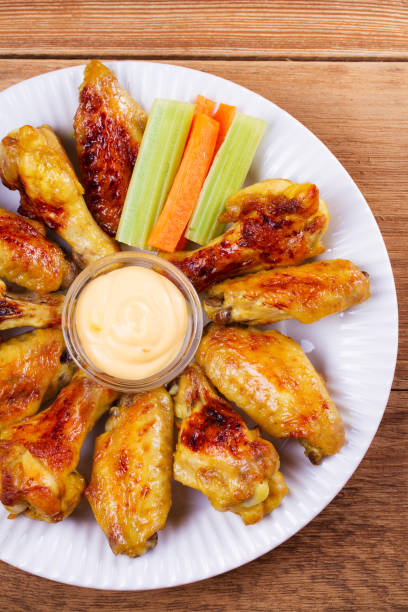 istock Chicken wings buffalo. Chicken with celery and carrot sticks 840496758