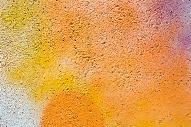 orange color painted wall texture background - detail of graffiti