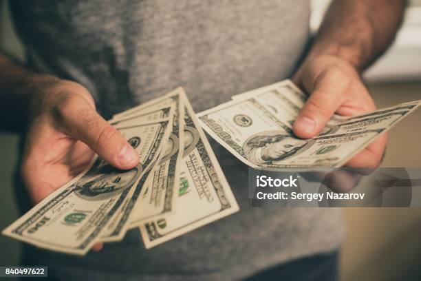 A Man Holds Dollars In His Hands Stock Photo - Download Image Now - Currency, Coin, Holding