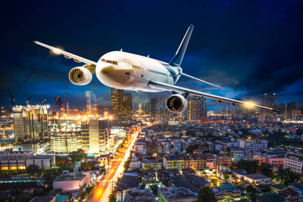istock Airplane over night scene city 840497918