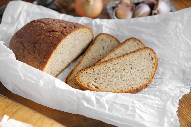 istock Farmer bread on baking paper, Vintage country table 840501120