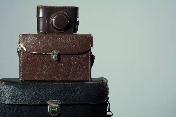 istock Background stack of old shabby suitcase with a camera in bag. 840501174