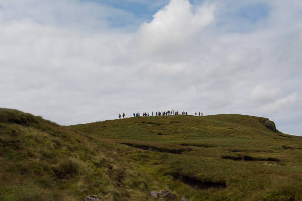 Large group of hill walkers on the top of Benbulben, Sligo, Ireland. Large group of hill walkers on the ridge of Benbulben, Co. Sligo, Ireland. ben bulben stock pictures, royalty-free photos & images