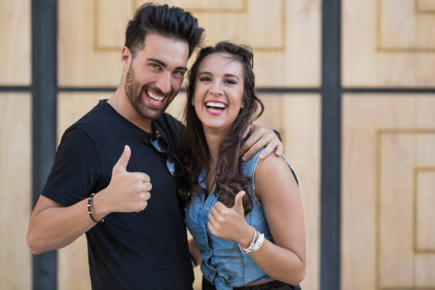 istock Young happy couple showing thumbs up 840505236