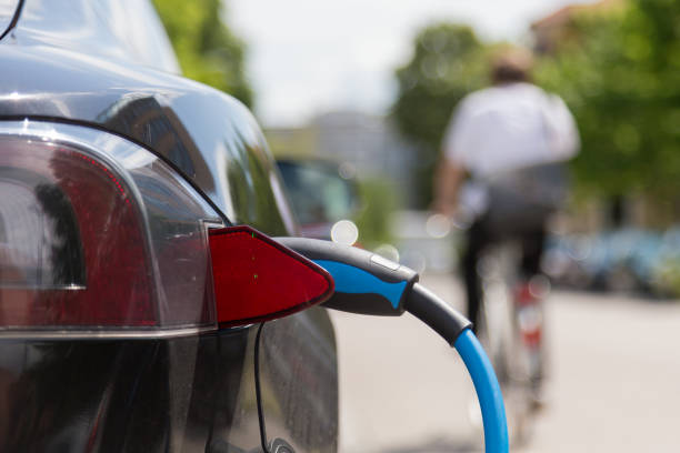 istock Power supply plugged into an electric car being charged. 840505344