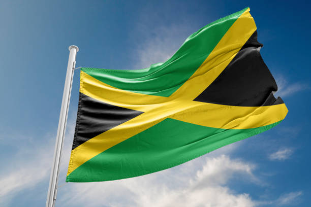 istock Jamaica Flag is Waving Against Blue Sky 840505938