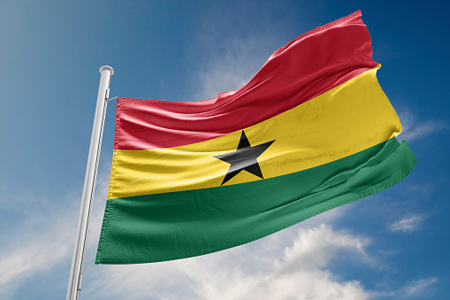 Ghana flag is waving at a beautiful and peaceful sky in day time while sun is shining. 3D Rendering