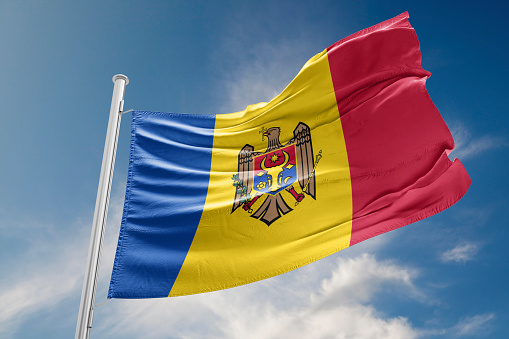 Moldova flag is waving at a beautiful and peaceful sky in day time while sun is shining. 3D Rendering