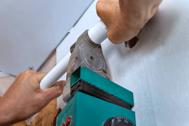 istock Man uses a heating machine for welding of polypropylene pipes. 840506200