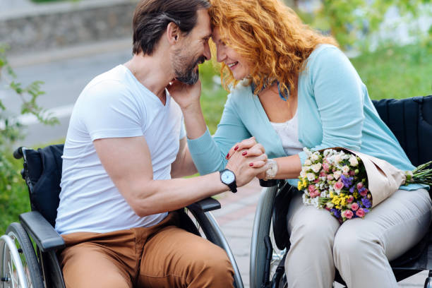 istock Positive wheelchaired senior couple expressing love 840509108