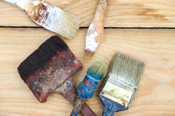 istock Brush on the blackboard, repair, construction, paint brushes in paint 840509436