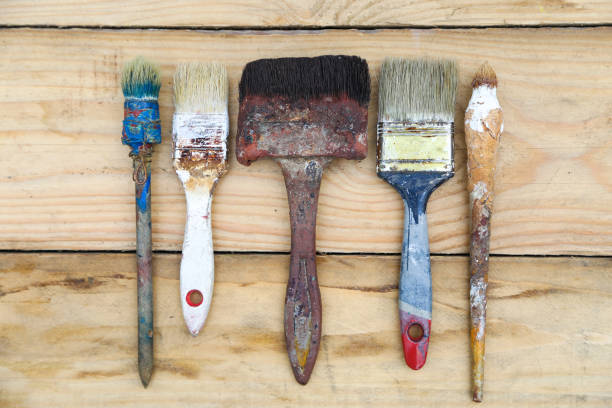 istock Brush on the blackboard, repair, construction, paint brushes in paint 840509444