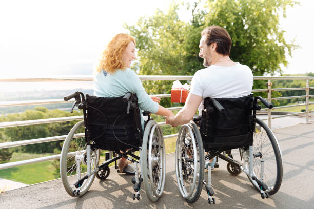 istock Cheerful senior couple resting outdoors in the wheelchairs 840512314